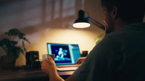 Freelancer work alone at computer late at night, process digital photograph.. Stock Footage 347723238