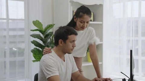 Freelancer work at home and his wife discussing their work. freelance workload. Stock Footage 171910682