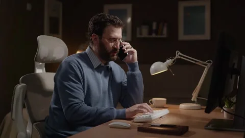 Freelancer at work, remote work concept. Focused man in home office talking on Stock-Footage 337646922