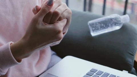 Freelancer working and cleaning hands with sanitizer. Stock Footage 126975930