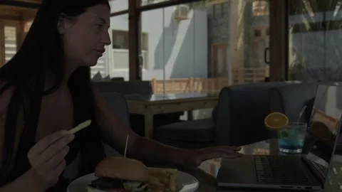 Freelancer working and eating lunch without looking away from laptop while Stock Footage 346252645