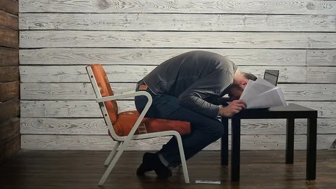 The freelancer working on the computer with the documents gets the bad news Stock Footage 83782443