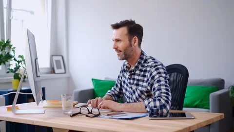 Freelancer working on computer from home office Stock Footage 126832114
