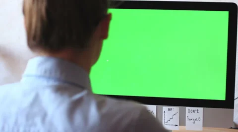 A freelancer working on a computer. On the monitor green screen, chroma key. Stock Footage
