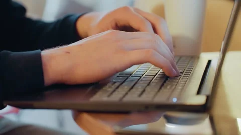 Freelancer working in cozy cafe. Focused fingers type code on portable device Stock Footage 338436173