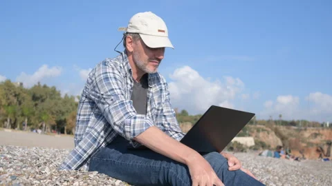Freelancer working with his laptop on a beach Stock Footage 305370882