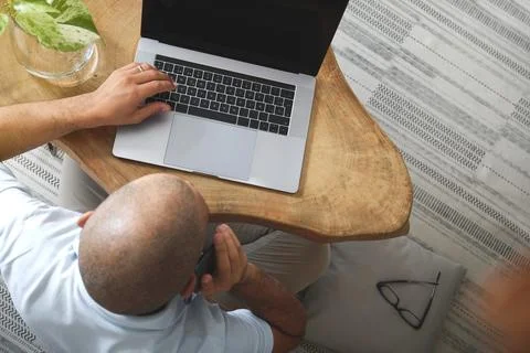 Freelancer working from home using laptop and smartphone 스톡 사진