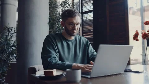 Freelancer Working With Laptop In Cafe During Breakfast Or Lunch, Portrait Of 動画素材 343669317