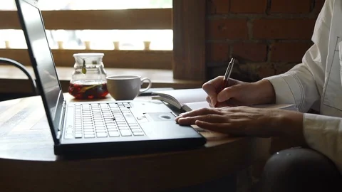 Freelancer Working on Laptop in a Cafe Video stock 110885184