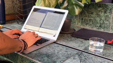 Freelancer working on a laptop from the cafe Stock Footage 125466470