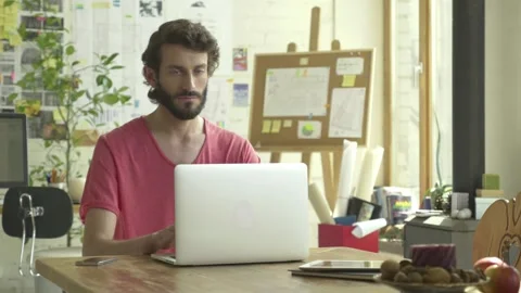 Freelancer working with laptop computer at his home studio. Typing, Stock Footage 245423144