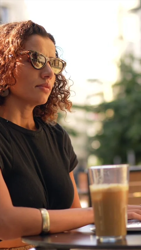 Freelancer working with mobile and laptop in a sidewalk cafeteria Stock Footage 302365529