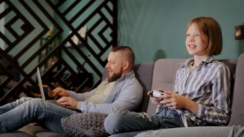 Freelancer working remotely, kid playing video game. Daughter having fun Stock Footage 265104803