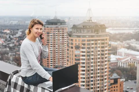Freelancer working on the rooftop of skyscraper Stock Photos