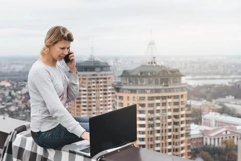 Freelancer working on the rooftop of skyscraper Stock Photos