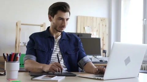 Freelancer working with tablet and laptop sketching new project Stock Footage 72874554