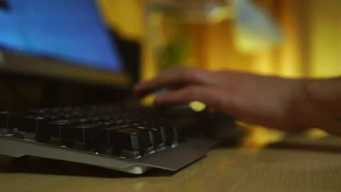 Freelancer works at a computer at night. man working at a computer desk close-up Stock Footage 146398091