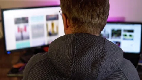 A freelancer works from home remotely on two computers. Video stock 203825652