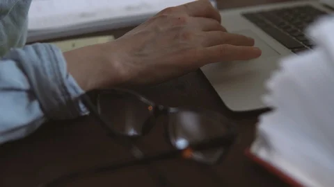 Freelancer works remotely over the Internet on his computer sitting in the home Stock Footage 88171851