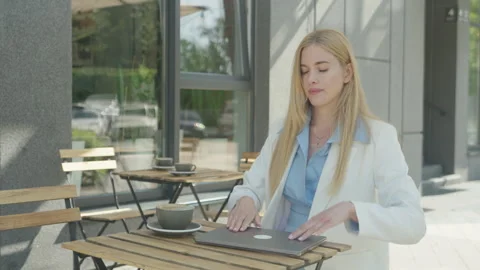 Freelancer Wrapping Up Work And Reflecting Over Coffee Outdoors Stock Footage 313839079