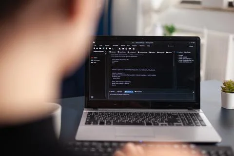 Freelancer writing code on laptop using keyboard. 스톡 사진