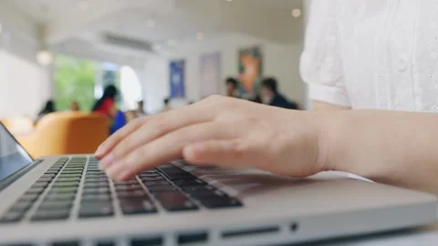 Freelancers often choose to work in coffee shops . With their laptops open an Stock Footage 241464573