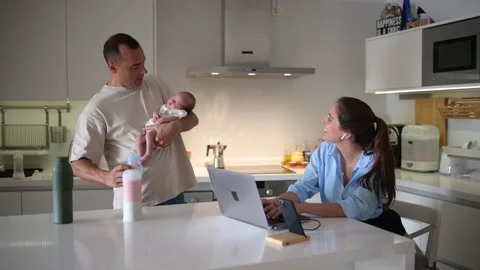 Freelancers working on project and taking care of baby Stock Footage 269354020