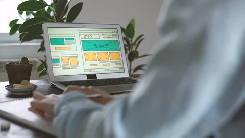 Freelancer's workplace. Web Developer makes sketches of the site in his notebook Video stock 88173411