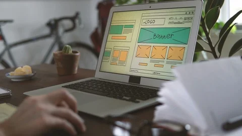 Freelancer's workplace. Web Developer makes sketches of the site in his notebook Vídeo Stock 88173535