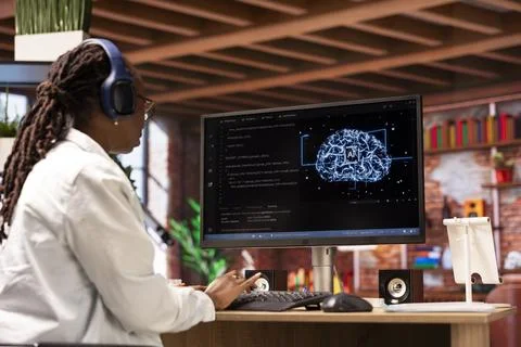 Freelancing computer engineer doing maintenance on AI, listening music Stock Photos