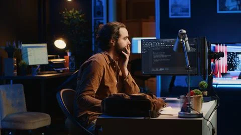 Freelancing IT system administrator arriving in personal office at home 库存照片