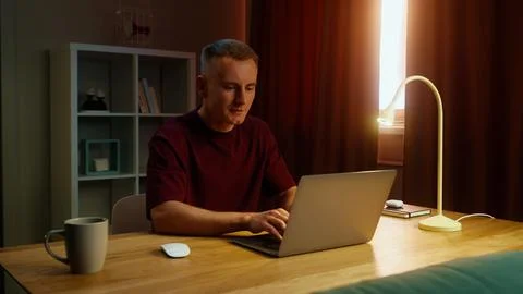 Freelancing man work at home sit table open computer laptop. Remote online jo 写真素材