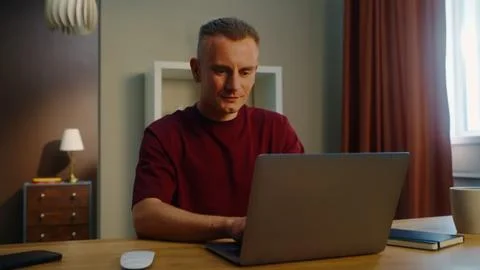 Freelancing man work at home sit table open computer laptop. Remote online jo 写真素材