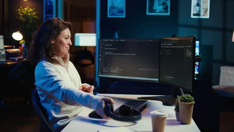 Freelancing programmer listening music while developing software Stock Footage 283592978