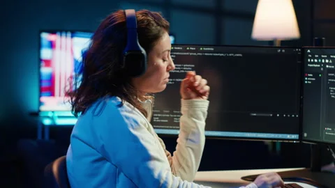 Freelancing programmer listening music while developing software Stock Footage 283595478