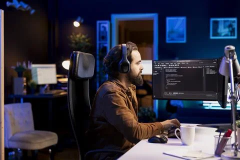 Freelancing programmer listening music while designing software Stock Photos