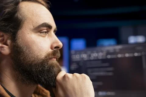 Freelancing programmer working from home, looking at desktop PC monitor Stock Photos