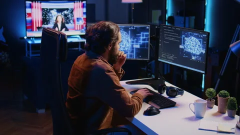 Freelancing programmer writes artificial intelligence code on desktop PC Stock Footage 265618403