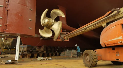 Freeport, Bahamas dry dock working at the propeller under a cruise ship Stock Footage 32157029