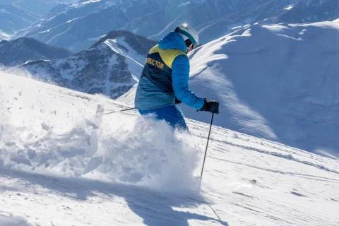 Freeride skier instructor, running downhill in freeze motion of snow powder.  Stock Photos