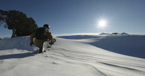 Freeride snowboarder climbing the mountain ridge. Extreme off-trail snowboarding Stock Footage 252463997