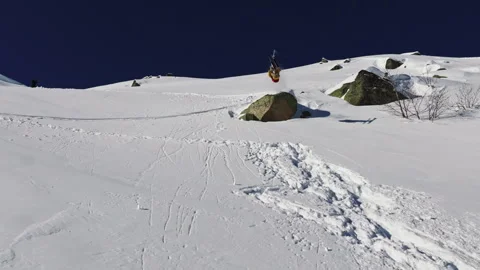 Freerider performing backflip jump on off-piste slope Stock Footage 315009748