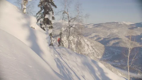 A freerider riding and jumping down the hill Stock Footage 102651867