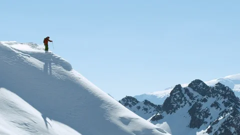 Freerider skiing down dangerous rocky terrain from high-altitude summit, Chile Stock Footage 121597603