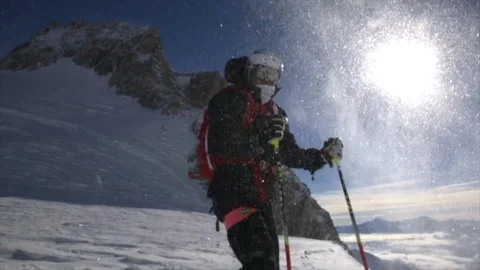 Freeskier on top of a mountain slowly through the sun Stock Footage 108651932