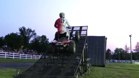 Freestyle atv 2 riders doing tricks at back to back on same jump 4k slow motion Stock Footage 81162185