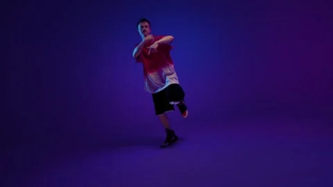 Freestyle dance man posing in purple studio light Stock Footage 345601590