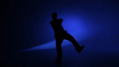 Freestyle dance pose under vivid blue studio light Stock Footage 345601209
