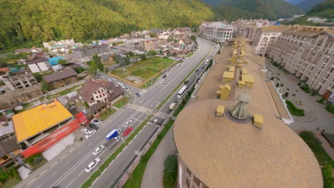 Freestyle drone flying above resort rooftops Stock Footage 311078044
