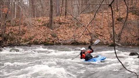 Freestyle kayaker rolls with the rapid waves of Winnipesaukee River. Stock Footage 93515285